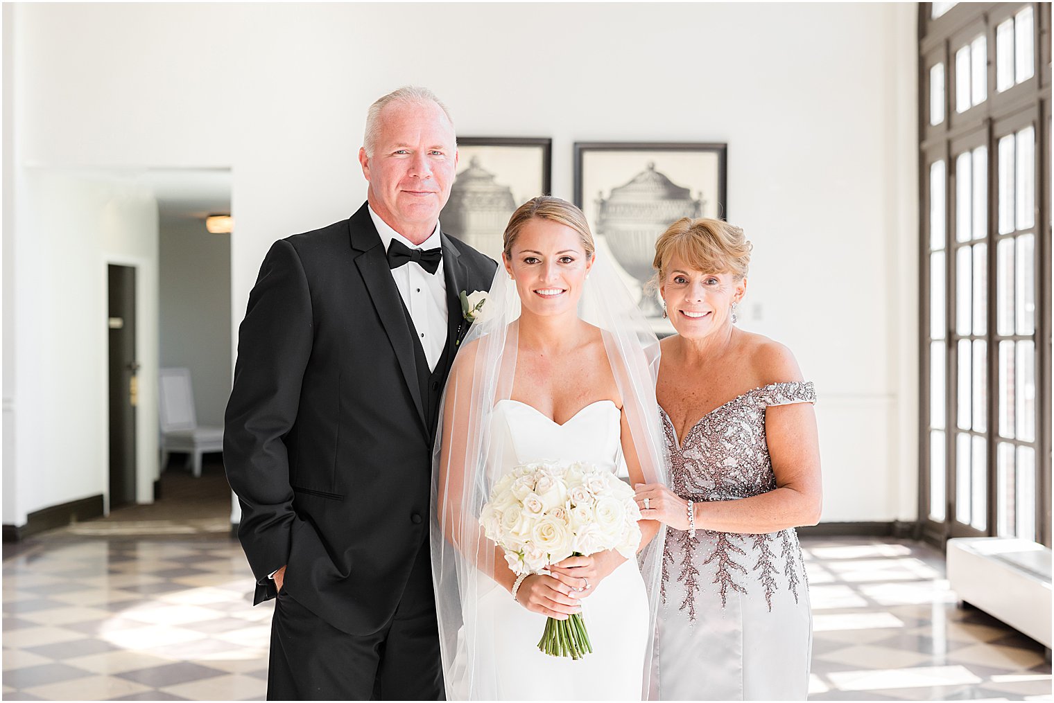bride poses with parents during NJ wedding day prpe