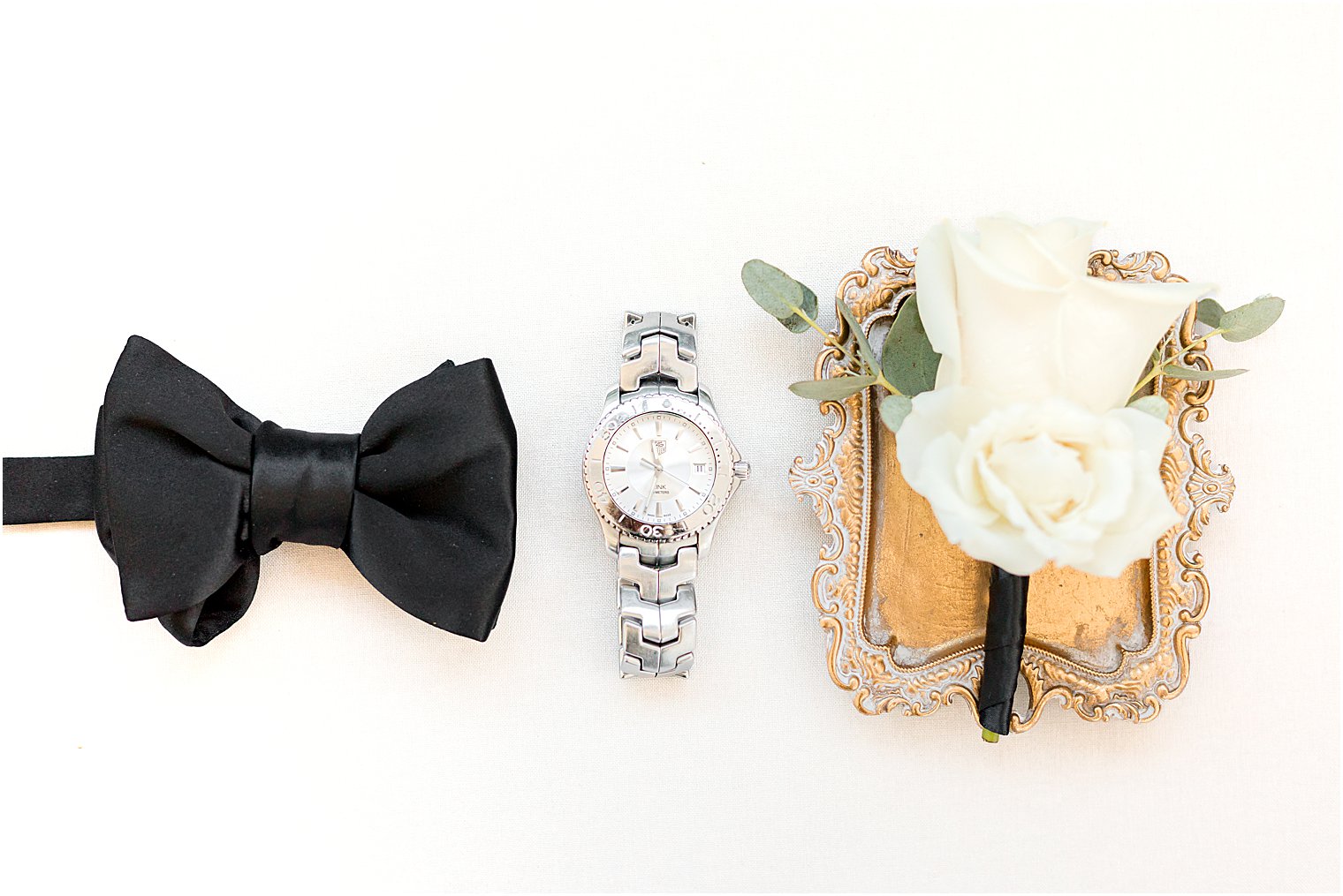 groom's classic black tie and white rose boutonnière 