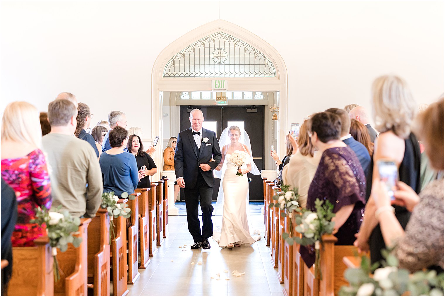 bride and father walk down aisle for traditional church wedding at St. Mary's Catholic Church