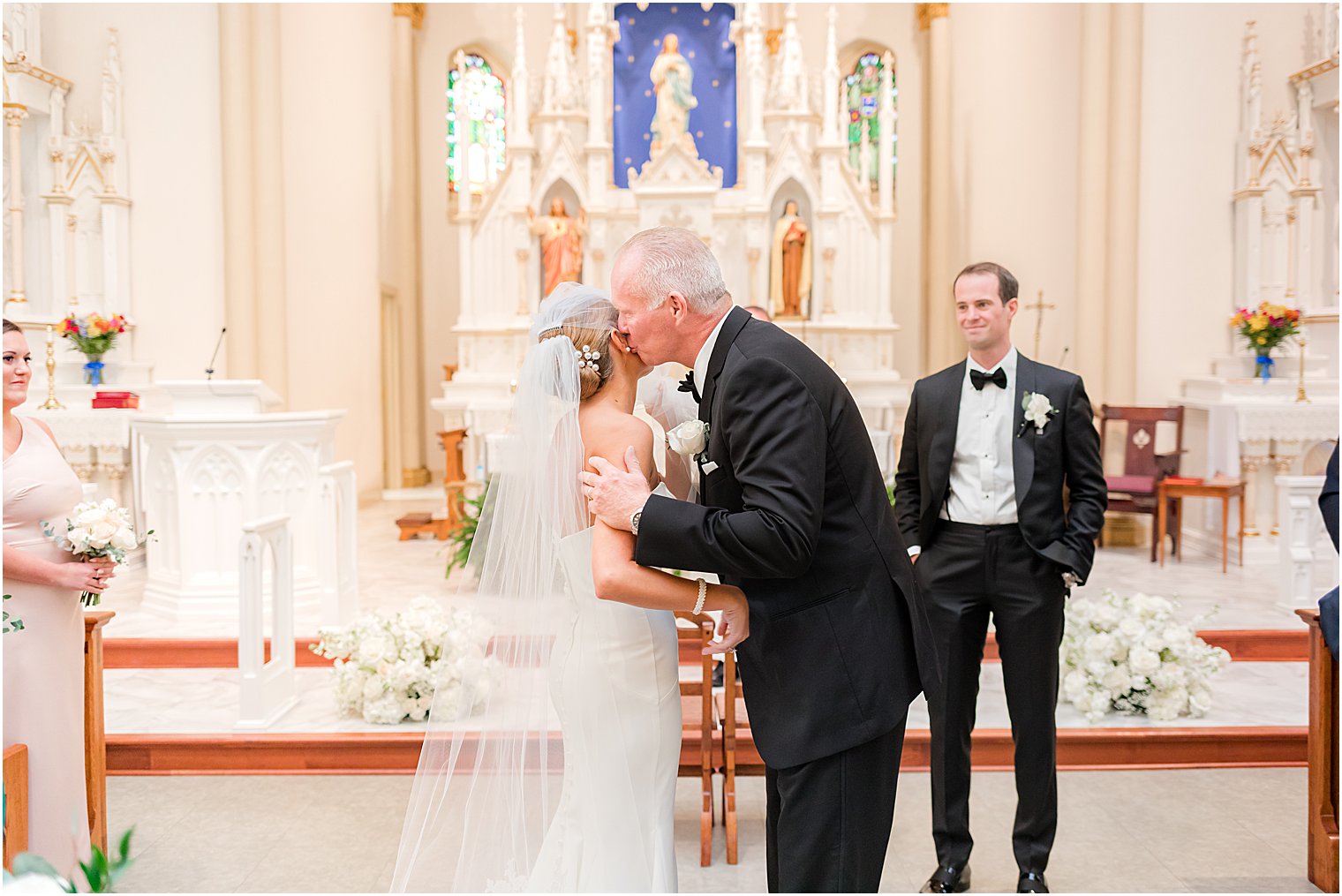 dad kisses bride's cheek before traditional church wedding at St. Mary's Catholic Church