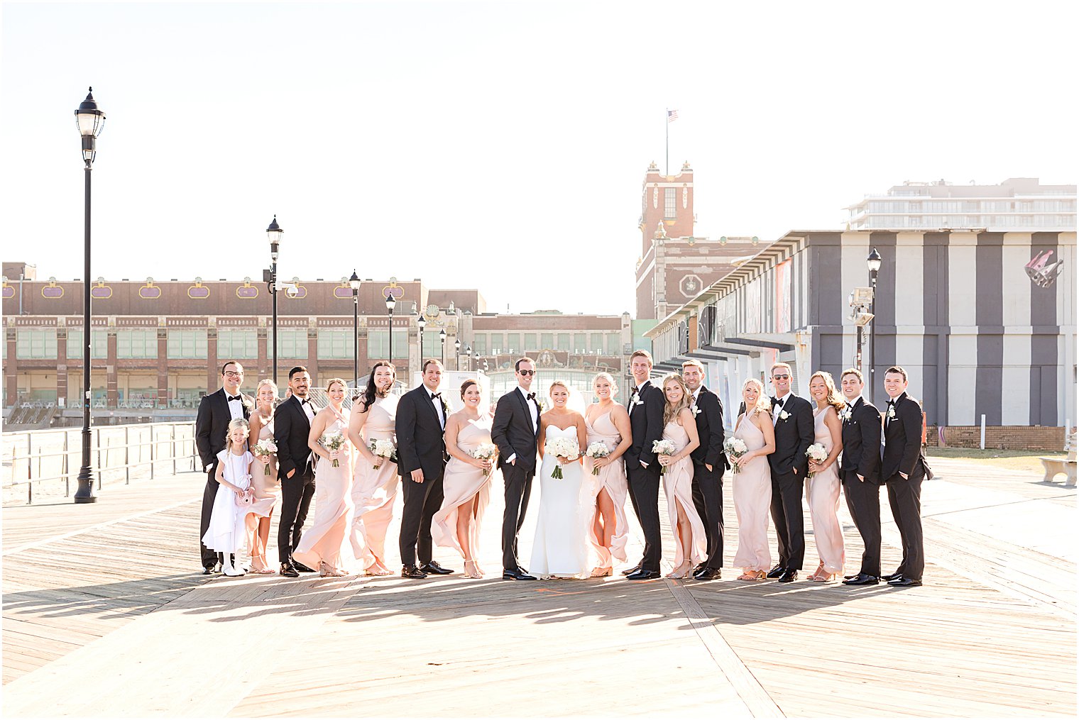 bride and groom pose with wedding party at Asbury Park