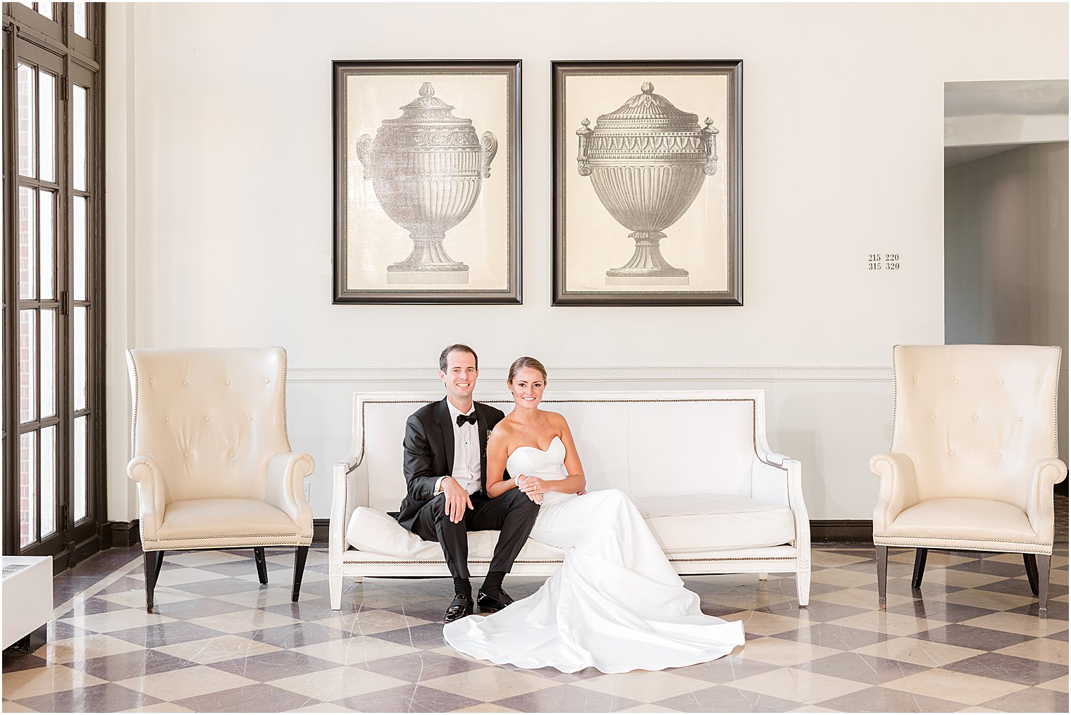 bride and groom sit on bench in lobby of the Berkeley Oceanfront Hotel