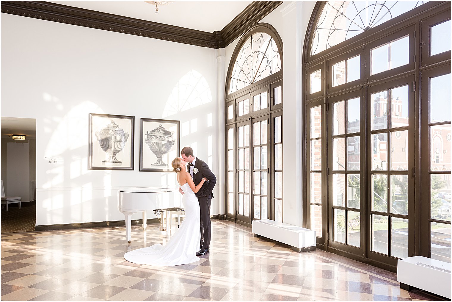 newlyweds kiss by windows inside the Berkeley Oceanfront Hotel