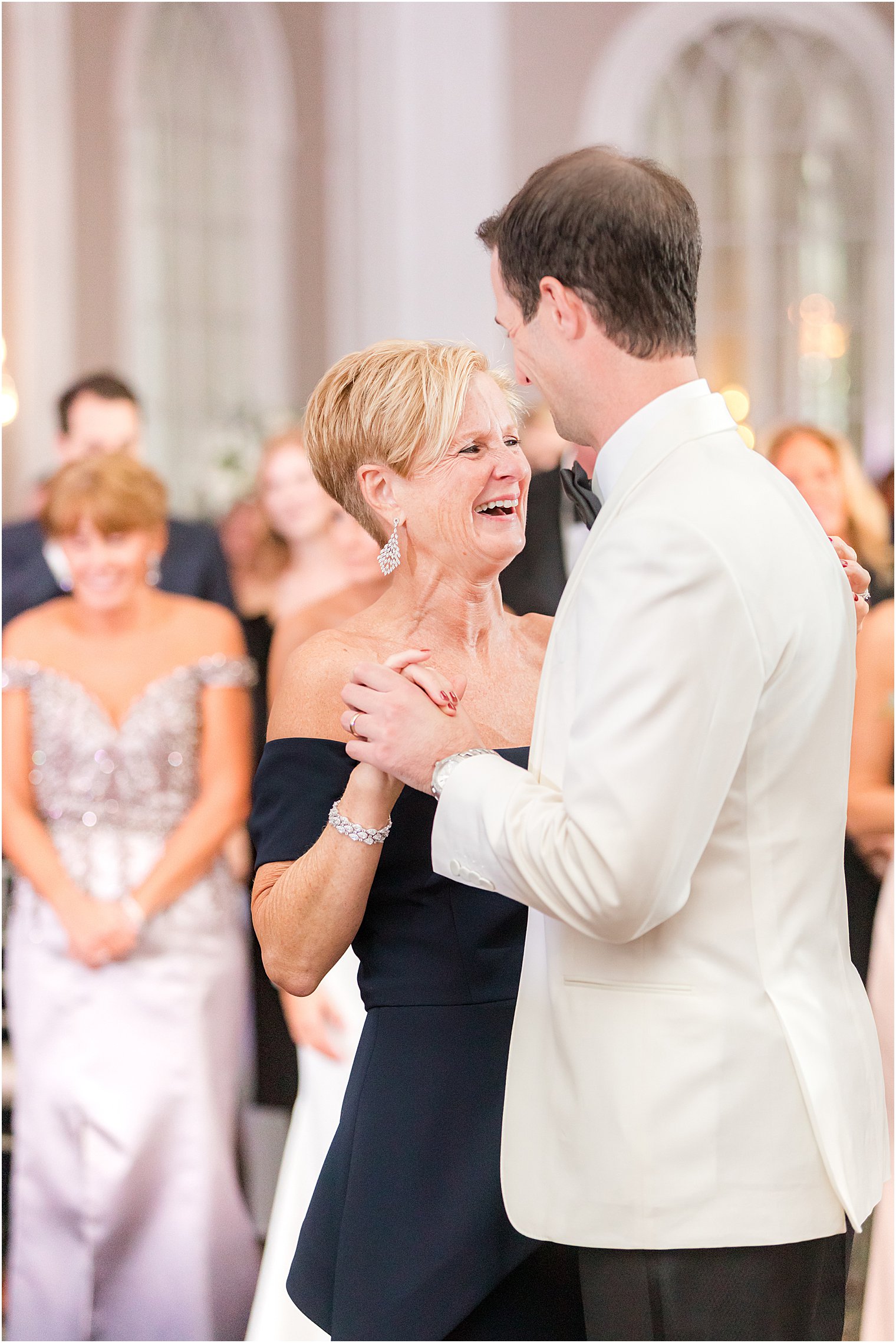 groom laughs with mom during dance at the Berkeley Oceanfront Hotel