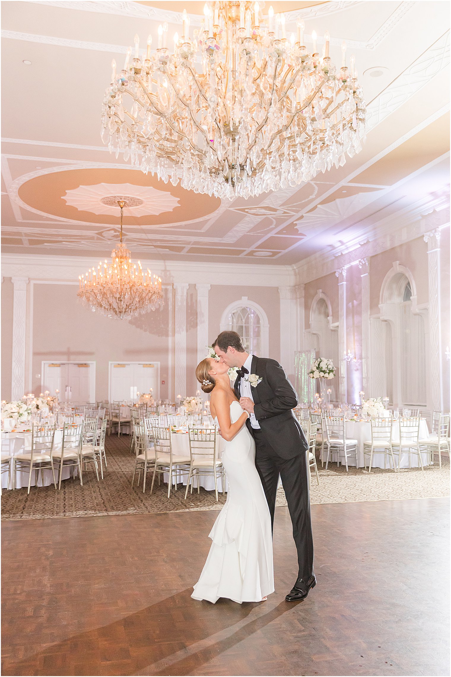 bride and groom kiss inside ballroom at the Berkeley Oceanfront Hotel