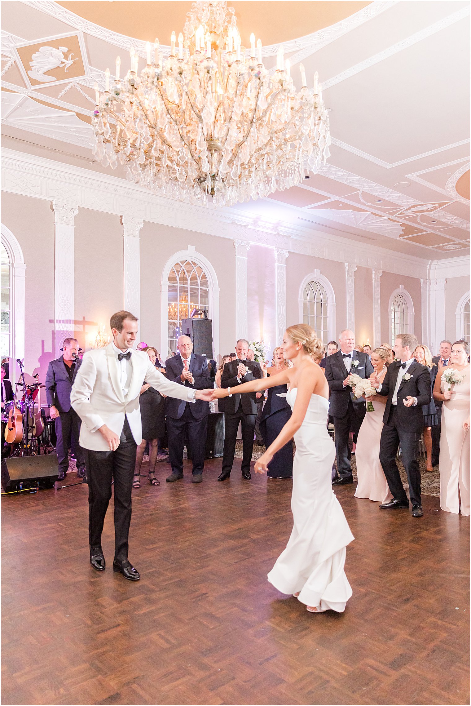 groom twirls bride during first dance at the Berkeley Oceanfront Hotel