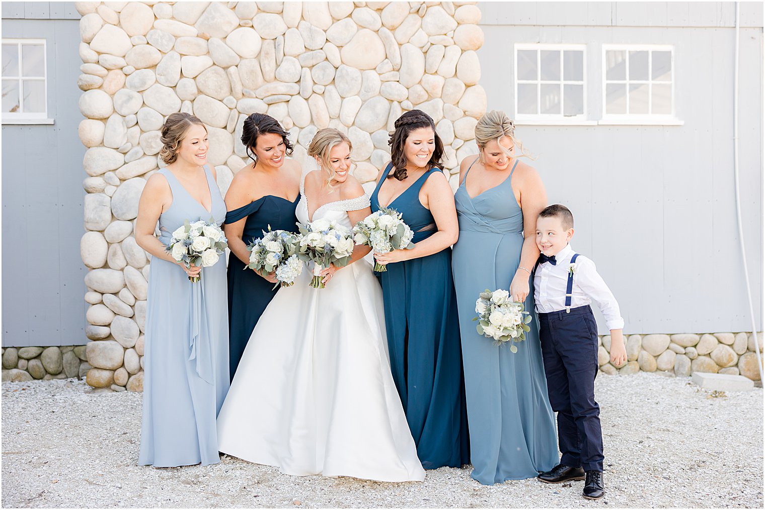 bride smiles with bridesmaids and ring bearer outside Bonnet Island Estate