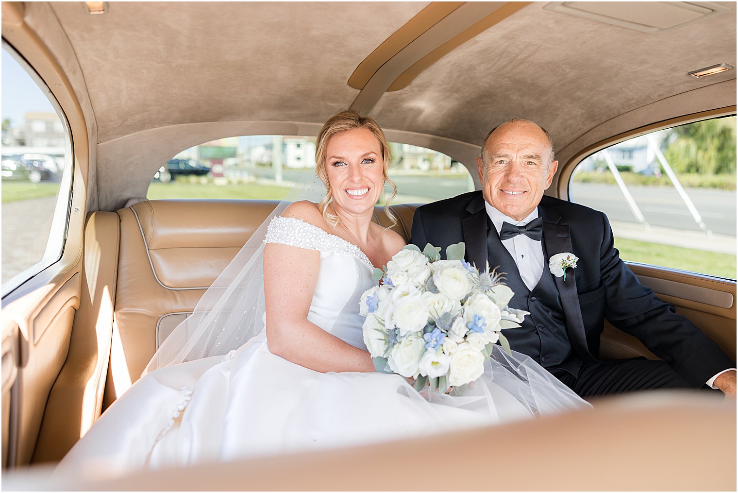 bride and dad sit in classic car outside church