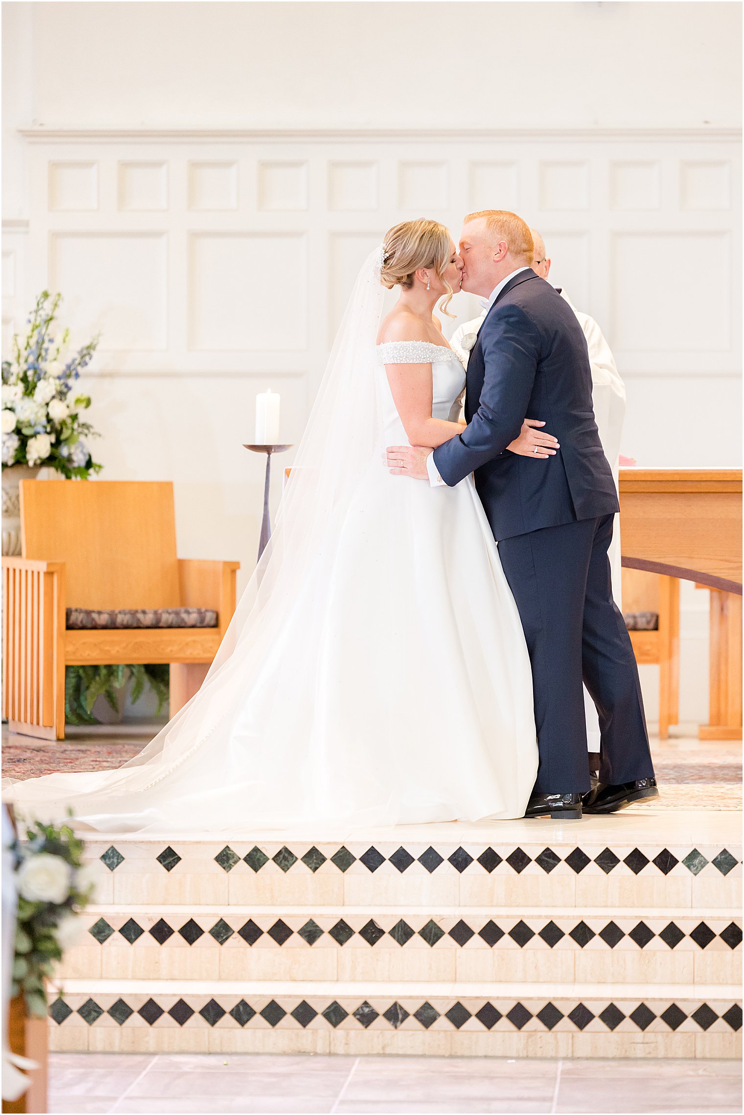 bride and groom kiss on alter during traditional church wedding on Long Beach Island