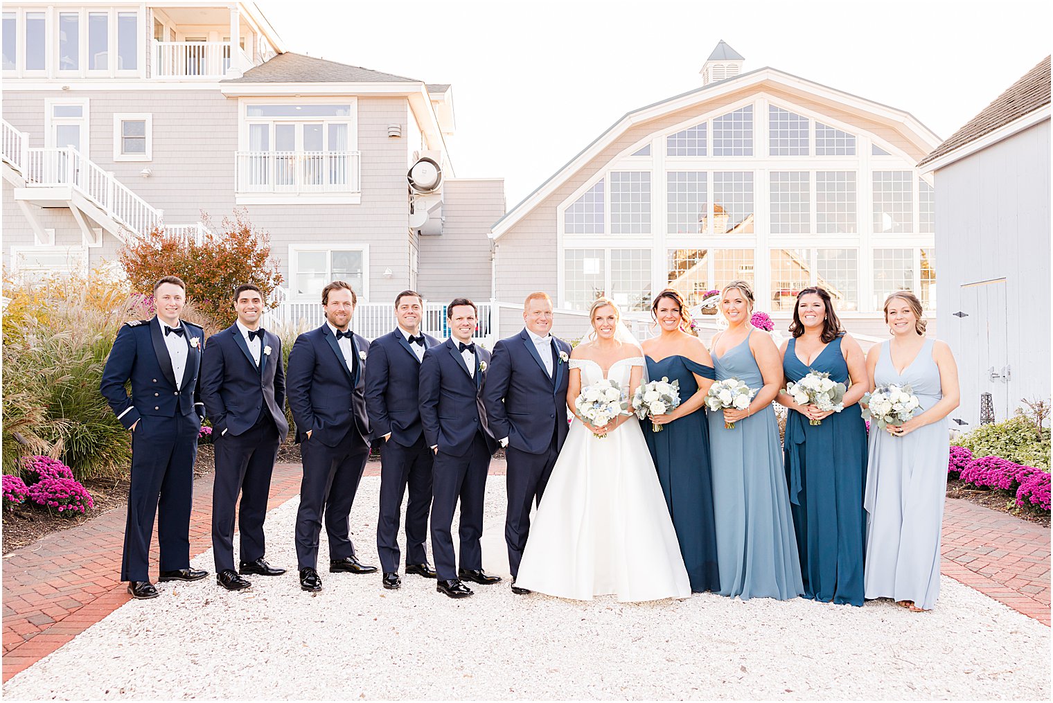 bride and groom stand with wedding party outside Bonnet Island Estate