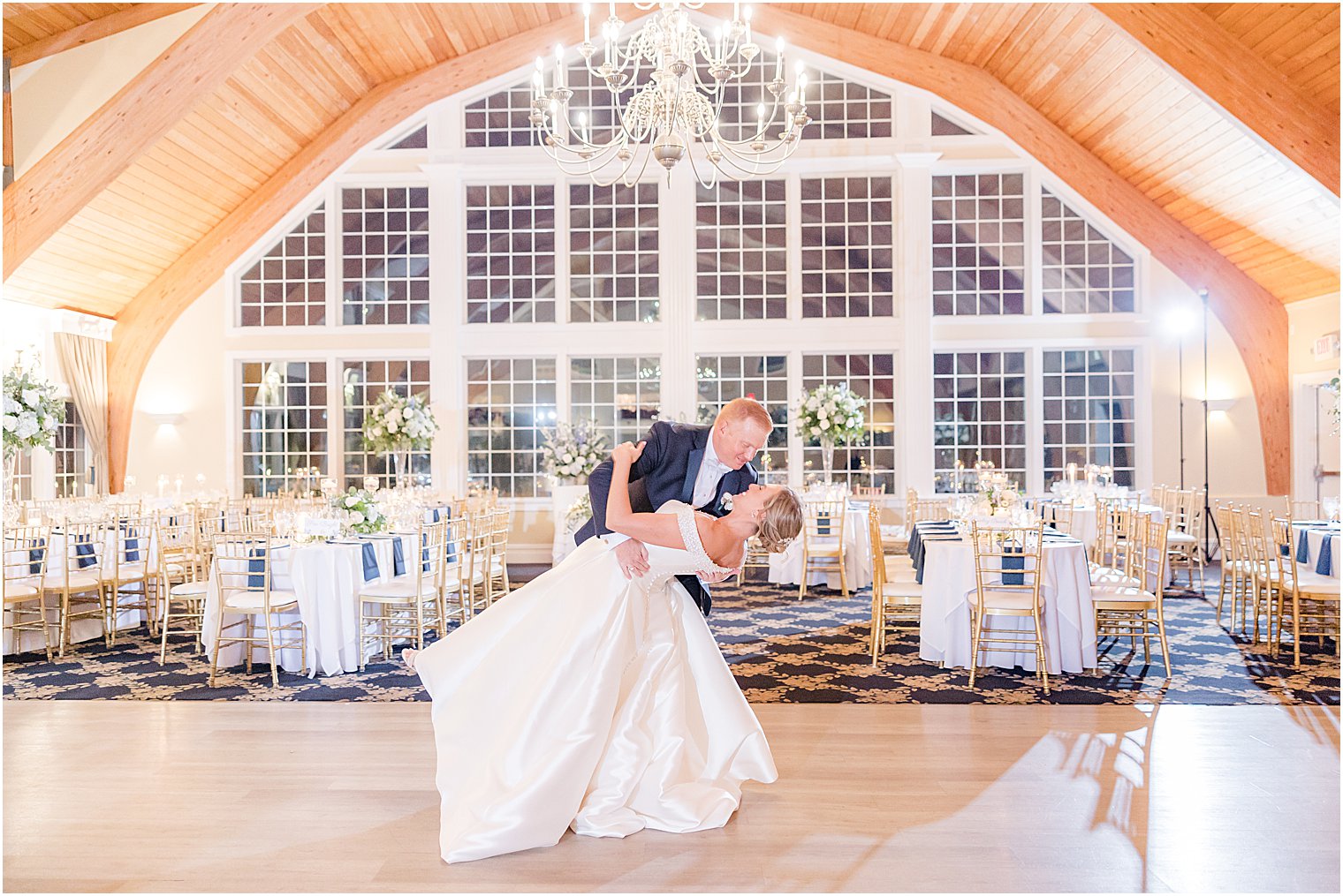 groom dips bride in ballroom at Bonnet Island Estate