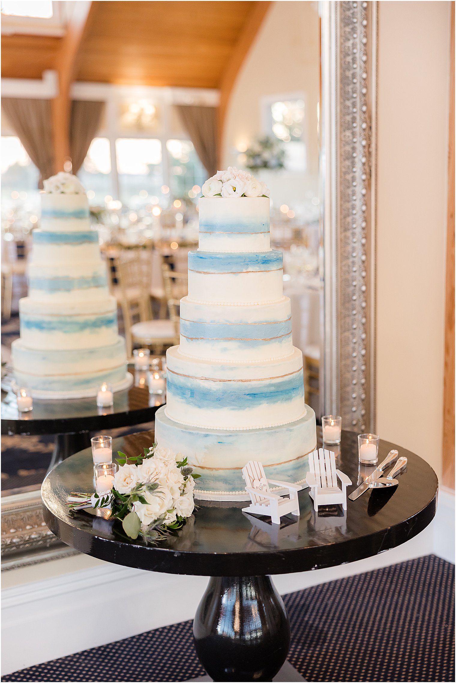 tiered wedding cake with blue icing and wooden chair details 