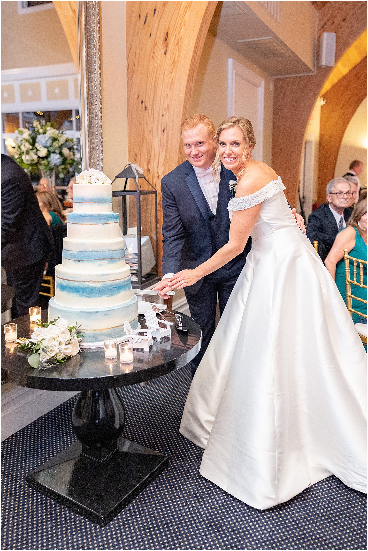 bride and groom cut wedding cake during LBI wedding reception