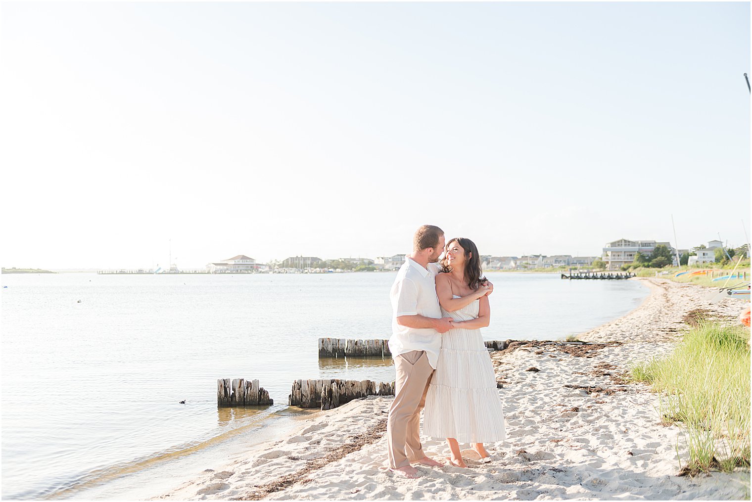 couple hugs on Lavallette Beach during engagement photos