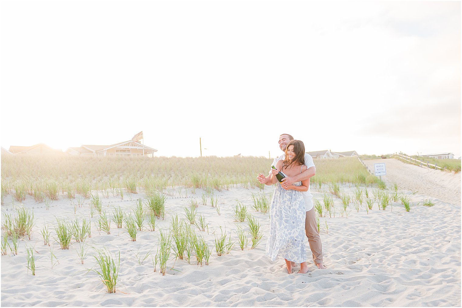 bride and groom pop champagne during engagement session 