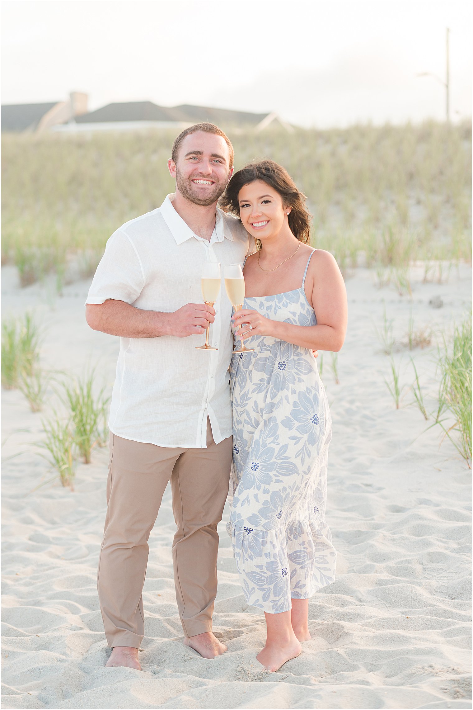 couple toasts champagne during engagement photos