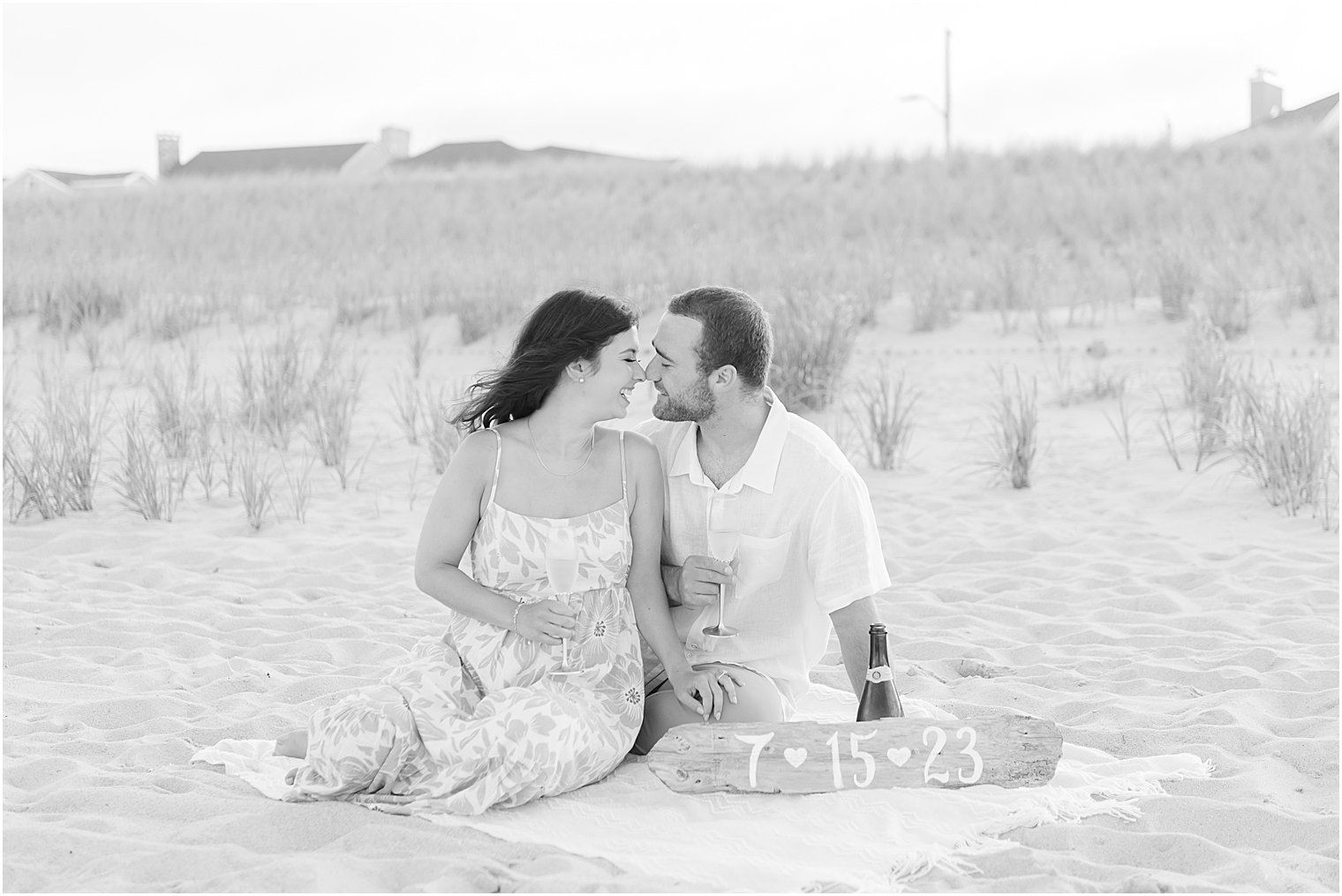 bride and groom sit on blanket on Lavallete Beach