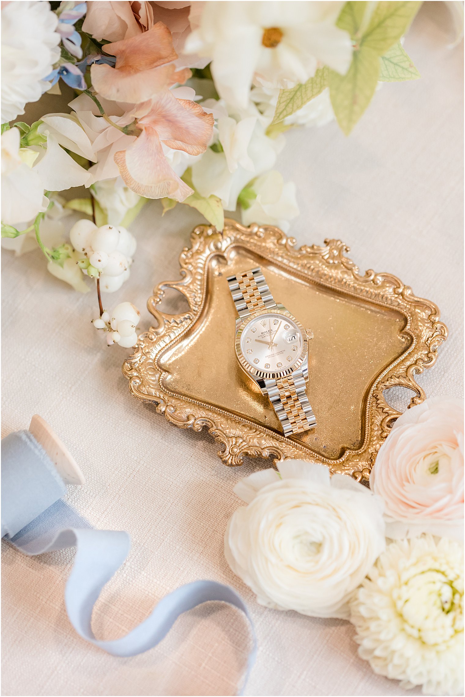 watch sits on gold tray in New Jersey for fall wedding