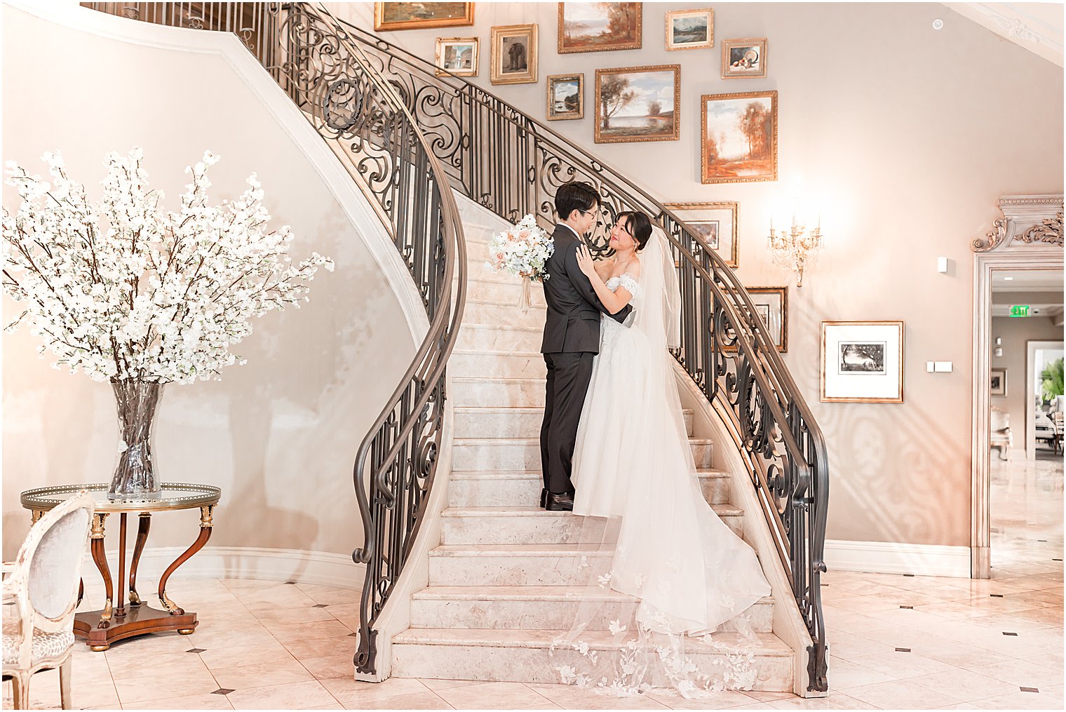 bride and groom hug on steps at Park Chateau Estate