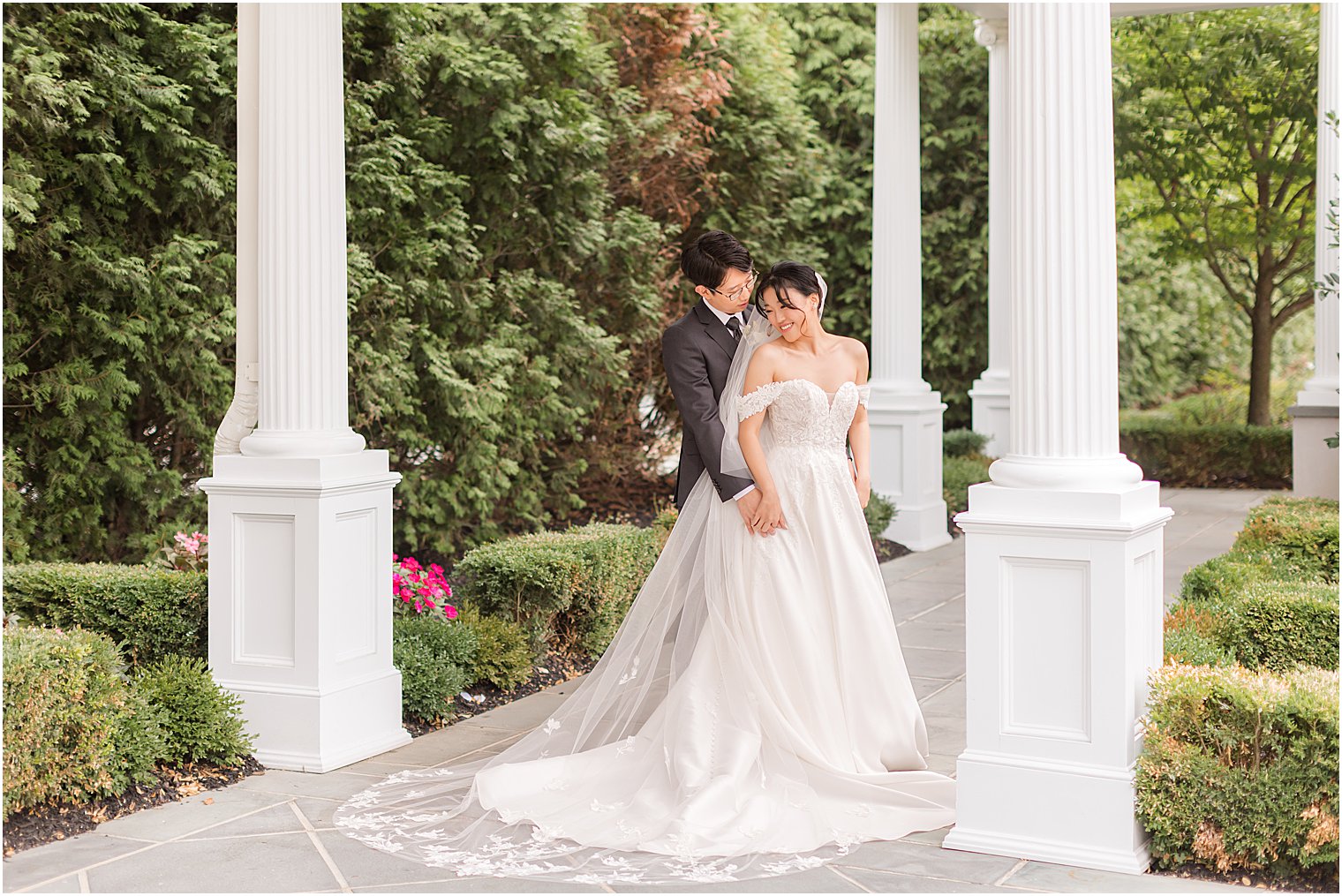 groom hugs bride from behind in New Jersey