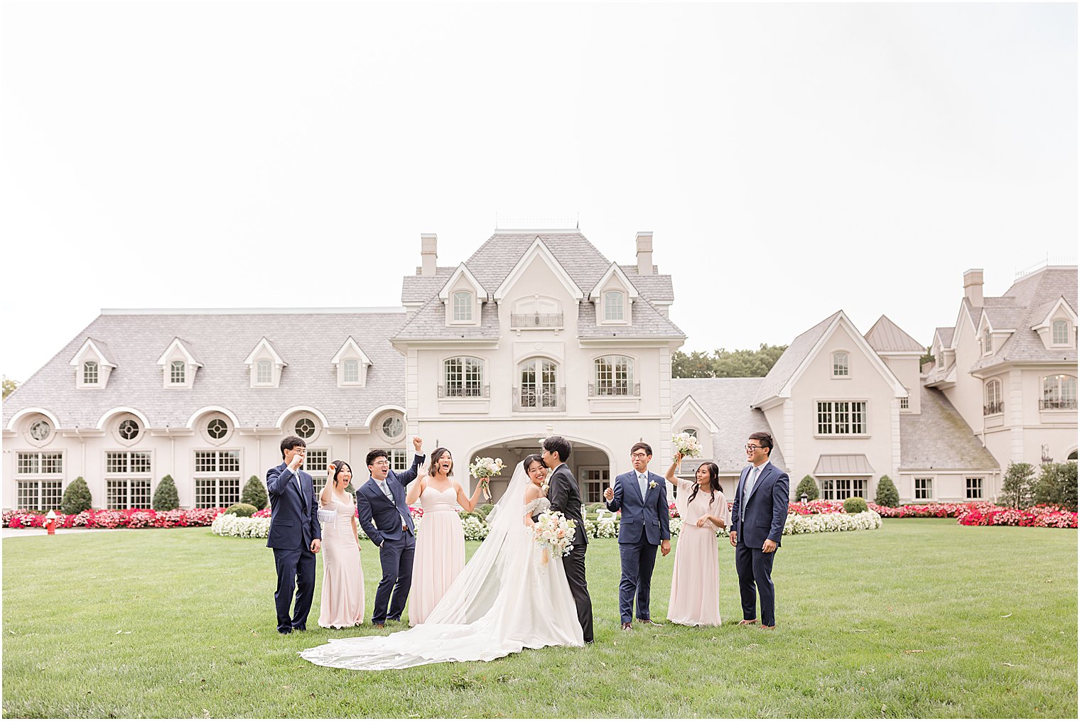 bride and groom stand on lawn with small bridal party at Park Chateau Estate