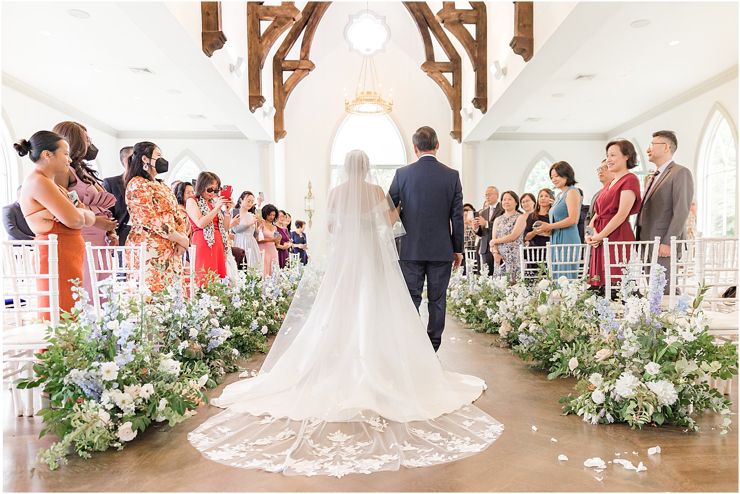 bride and father walk down aisle in Park Chateau chapel