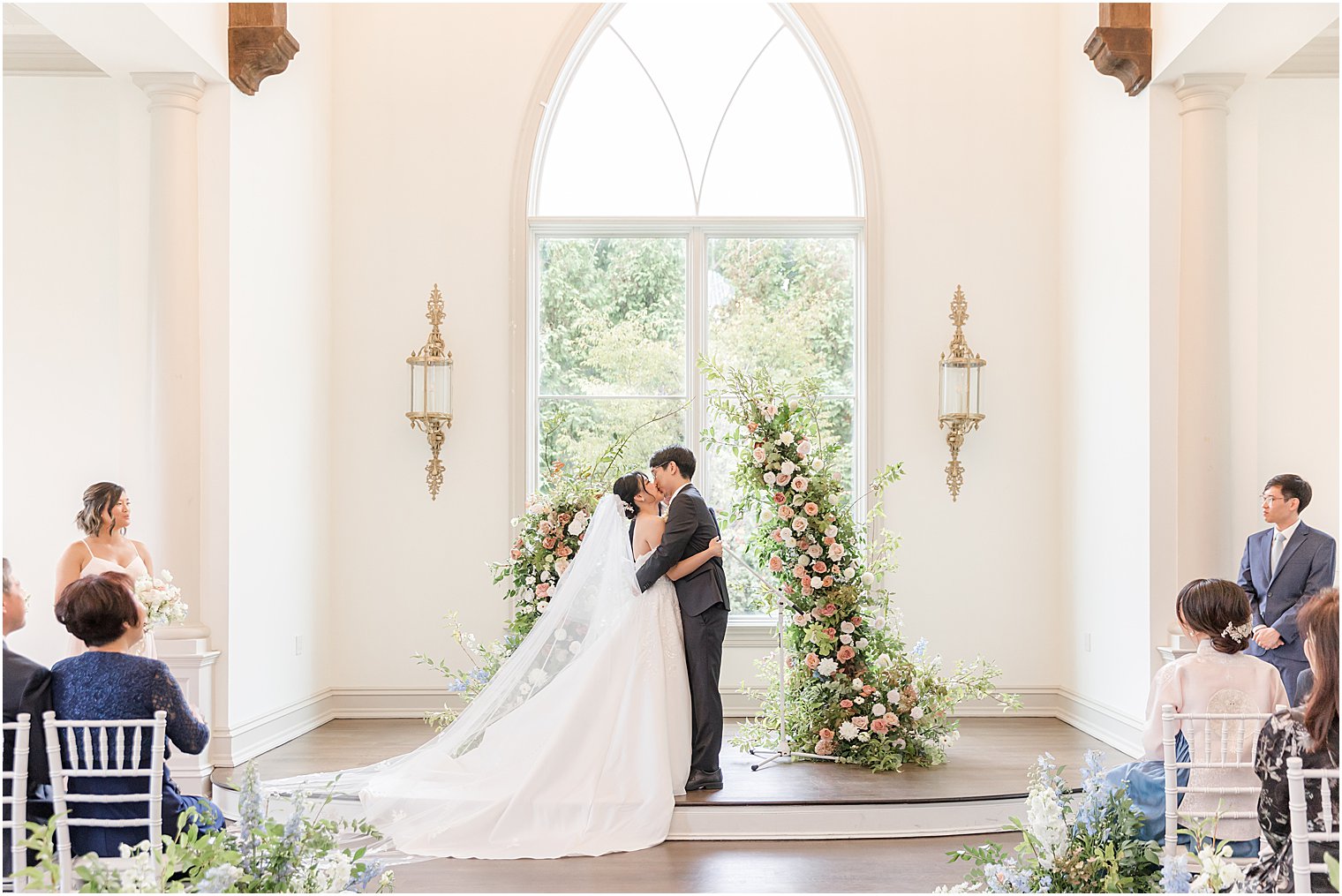 bride and groom kiss during ceremony in Park Chateau chapel