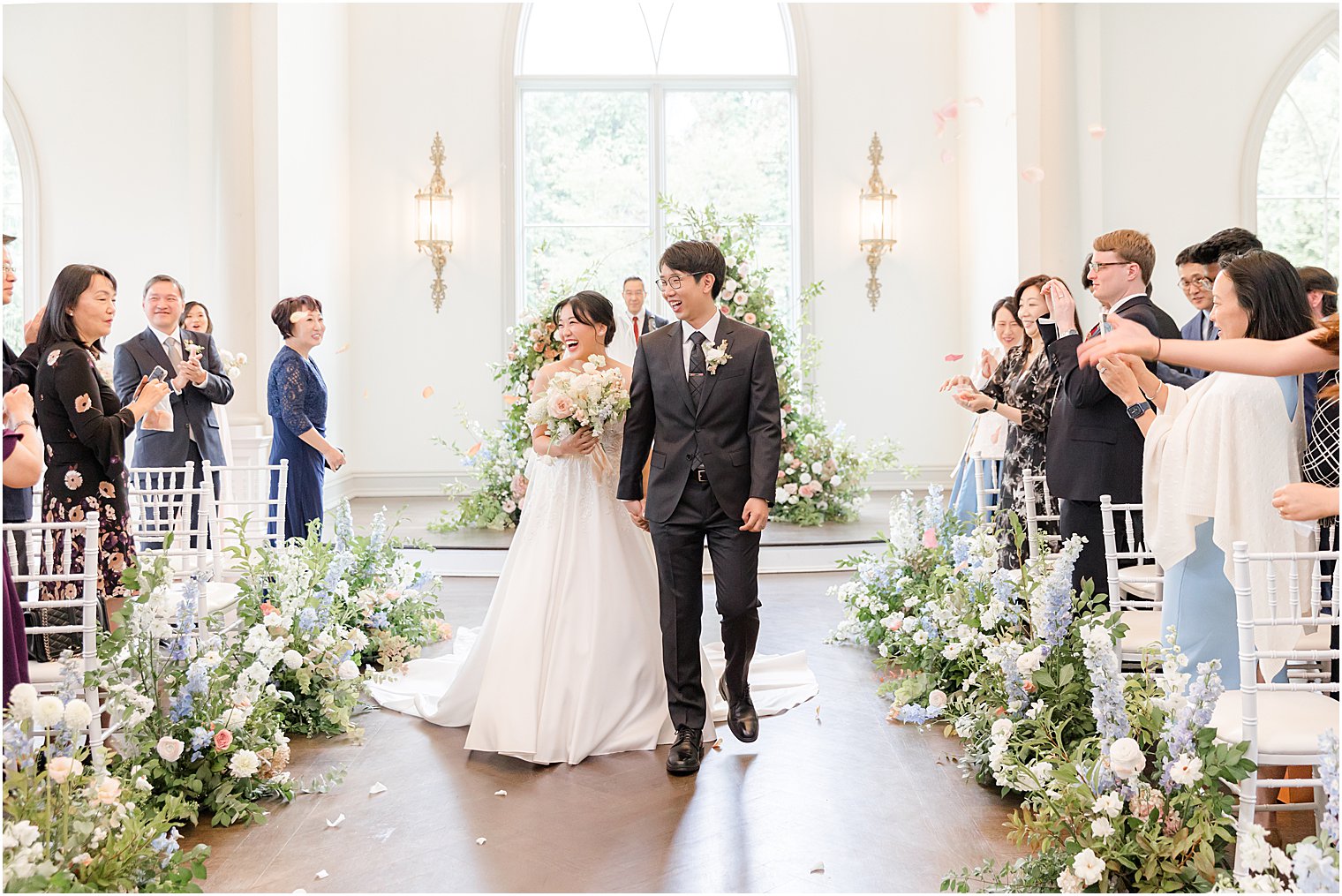 bride and groom walk up aisle after ceremony in Park Chateau chapel