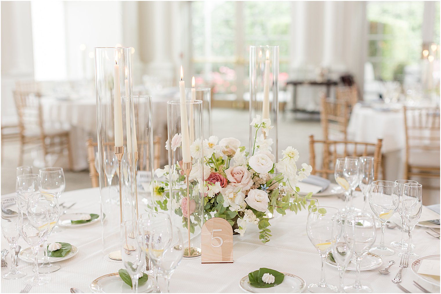 centerpieces with pink and white flowers and candles at Park Chateau Estate 