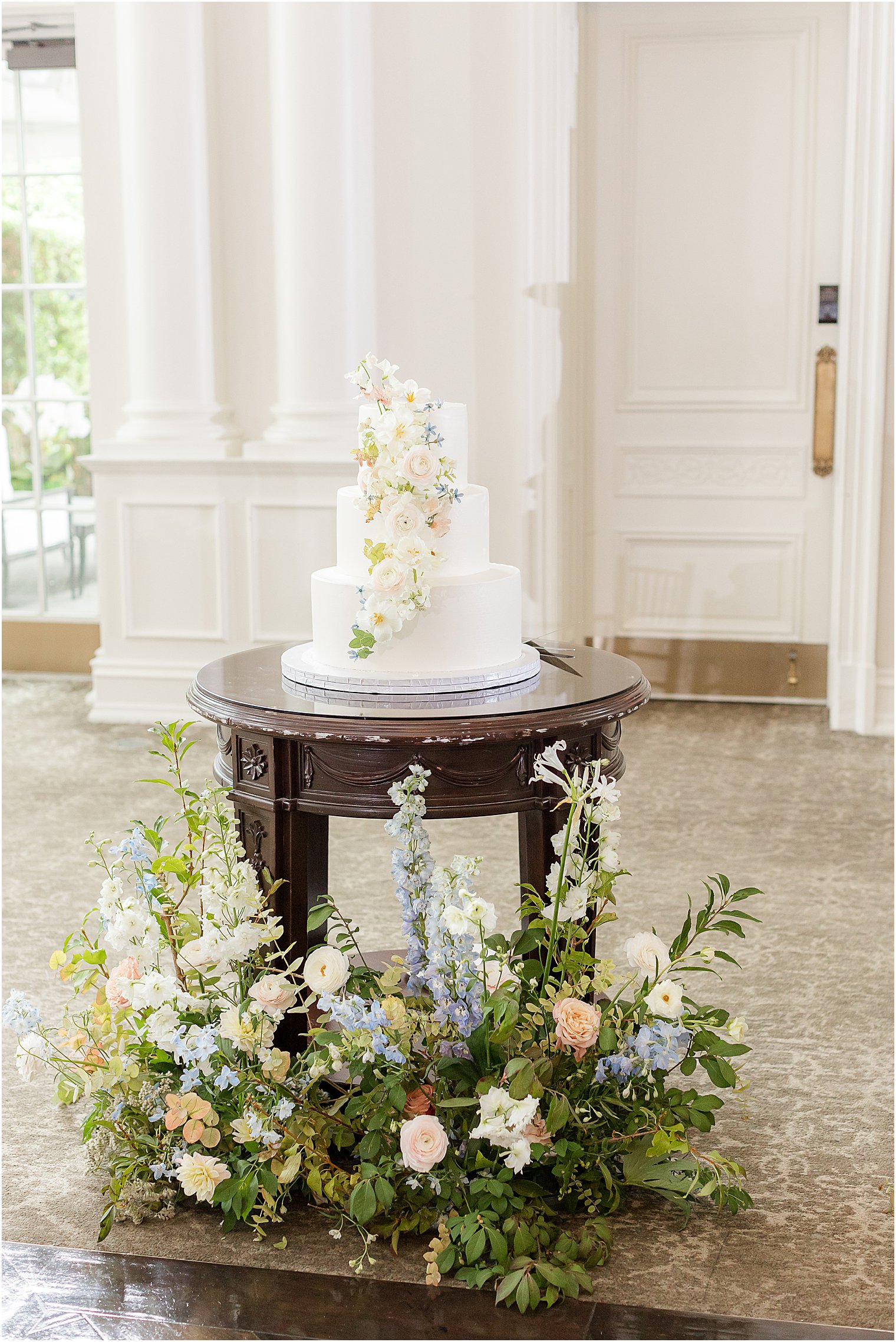 wedding cake sits on brown table at Park Chateau Estate 