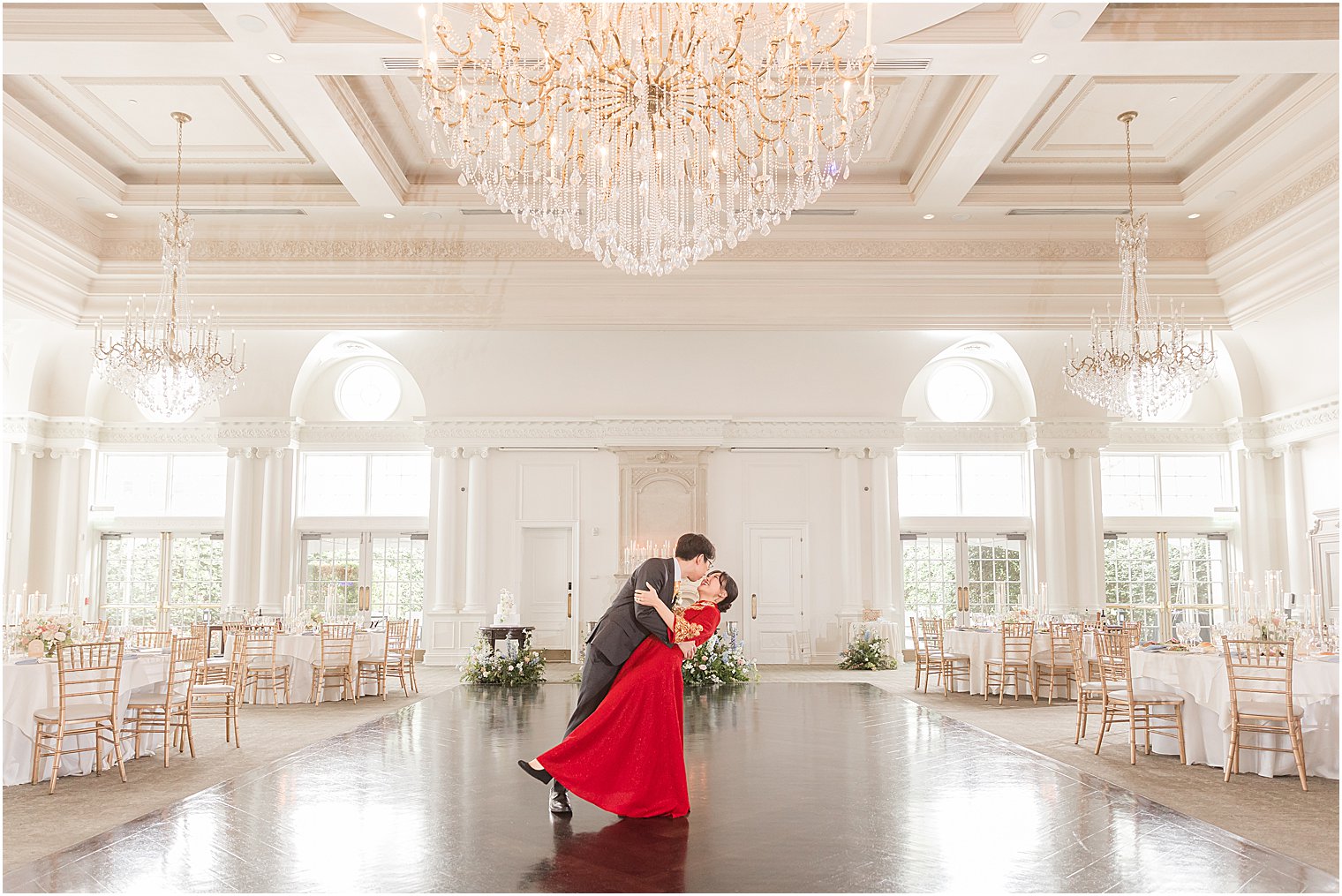 groom dips bride in red gown at Park Chateau Estate 