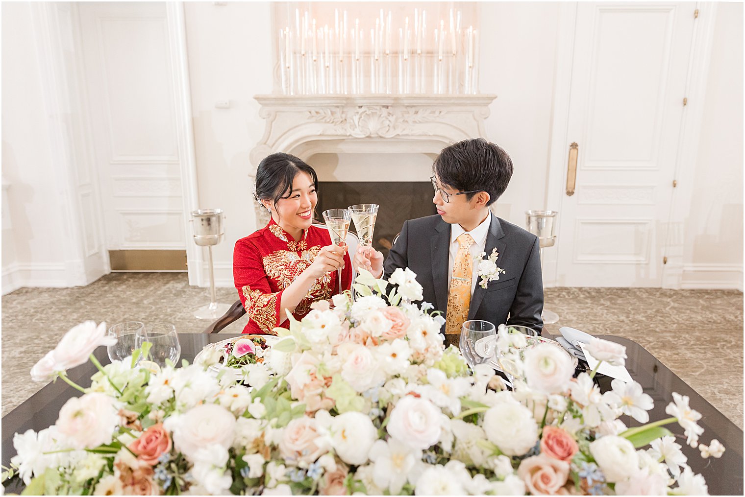 bride and groom sit at sweetheart table at Park Chateau Estate 