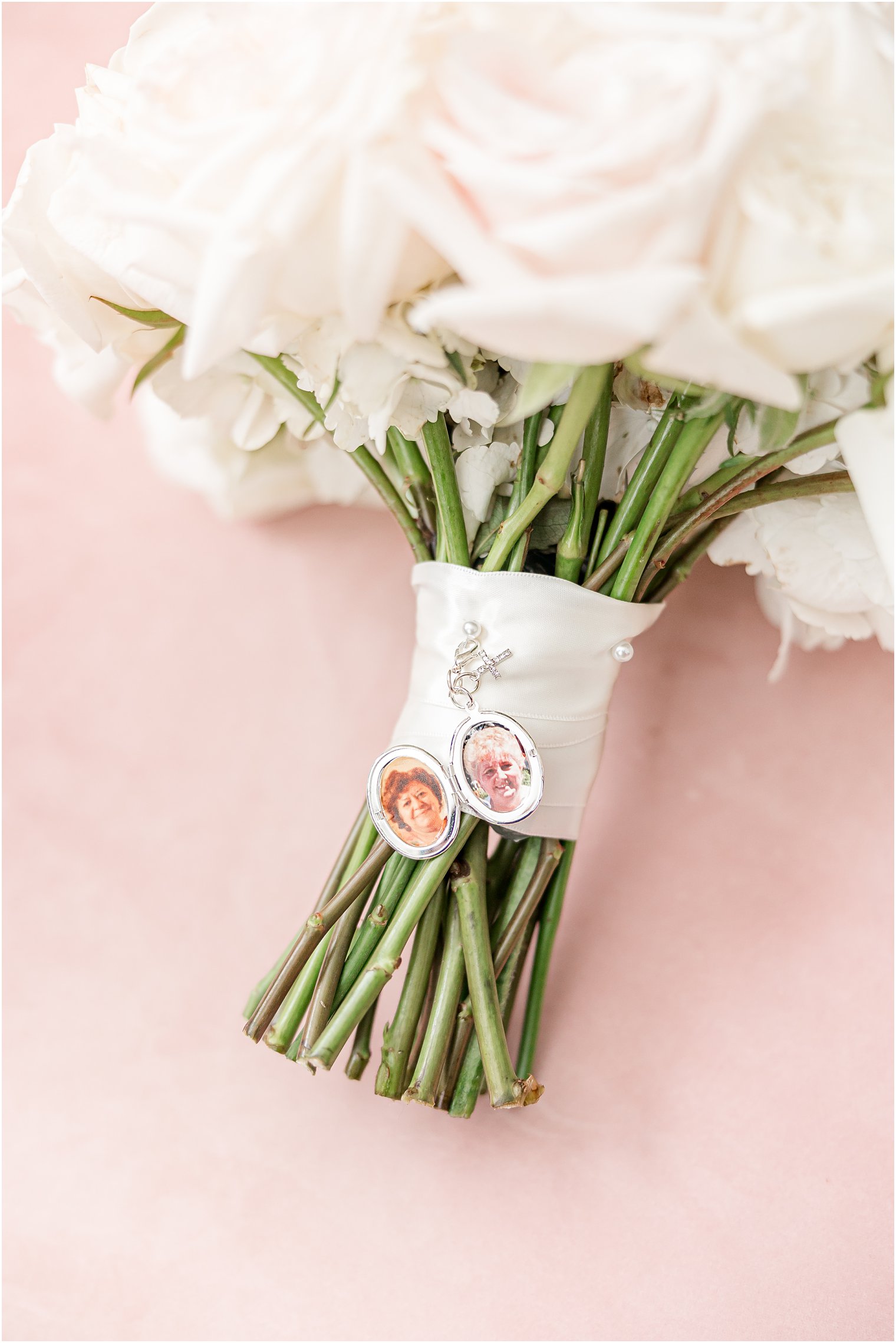 bride's bouquet with locket of grandparents on stems 