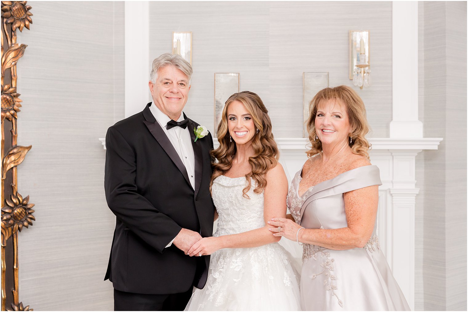 bride poses with parents during first look at Shadowbrook at Shrewsbury