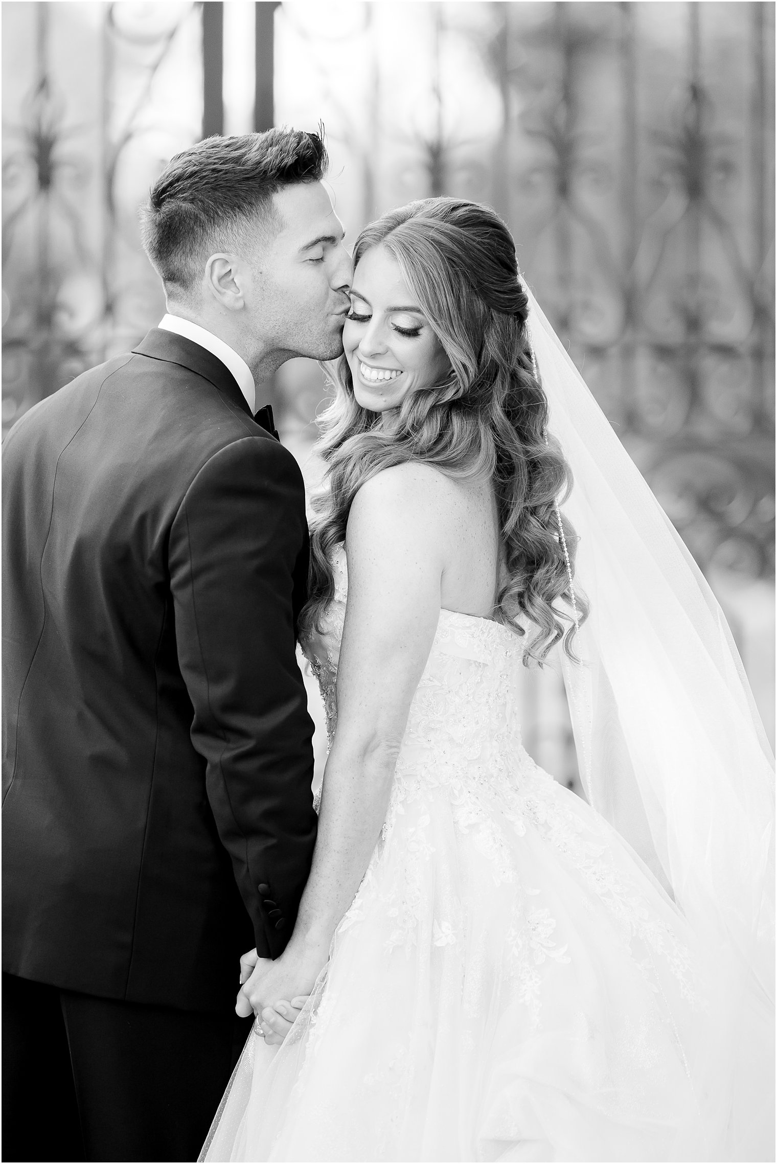 groom kisses bride's cheek during portraits in New Jersey 