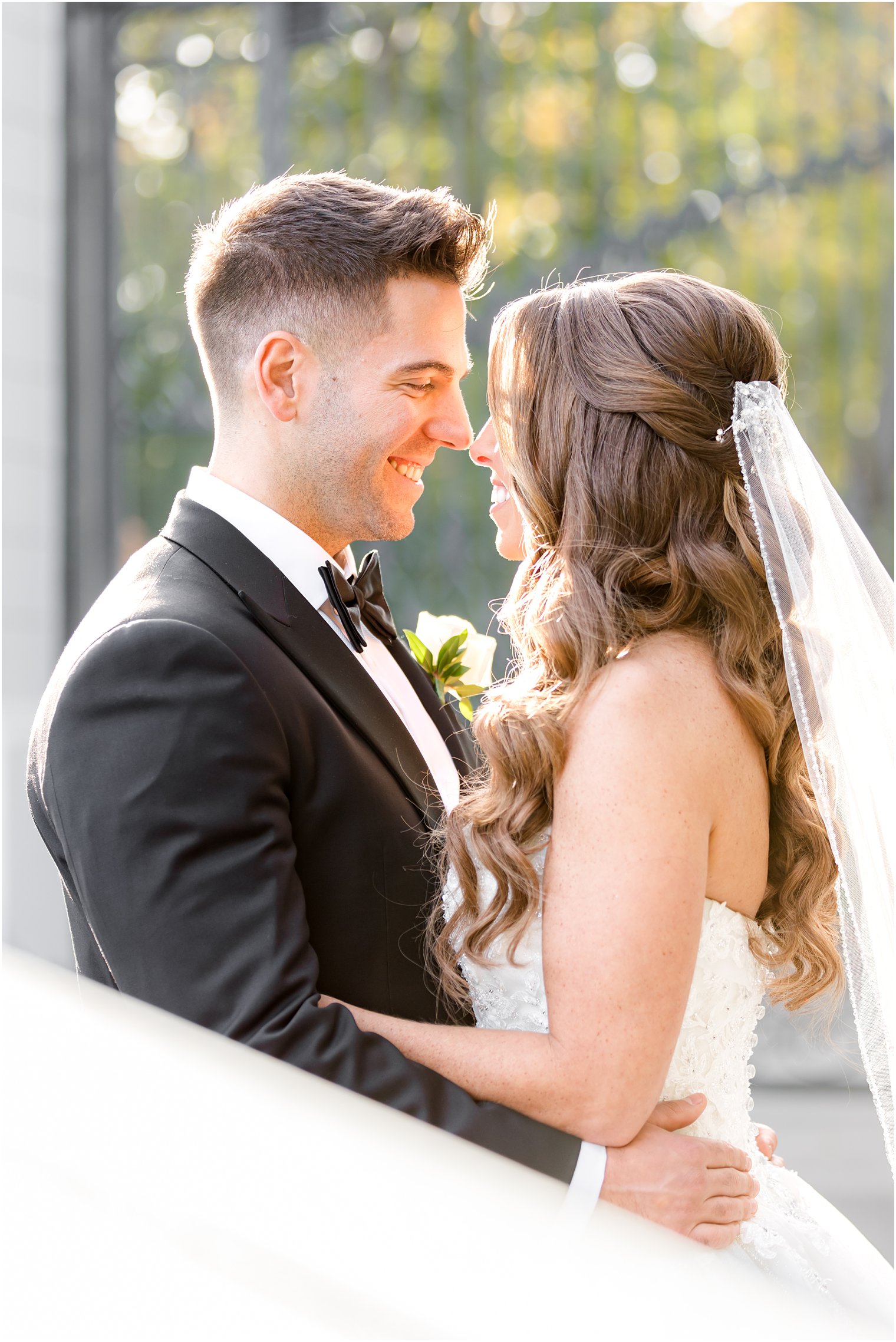 bride and groom laugh touching noses during Shadowbrook at Shrewsbury wedding portraits 