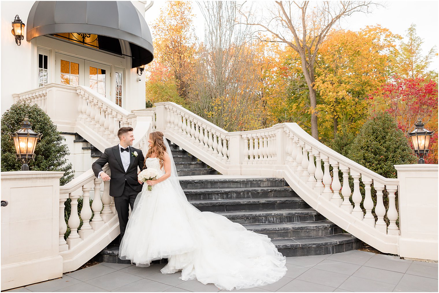 bride and groom hug near staircase at Shadowbrook at Shrewsbury