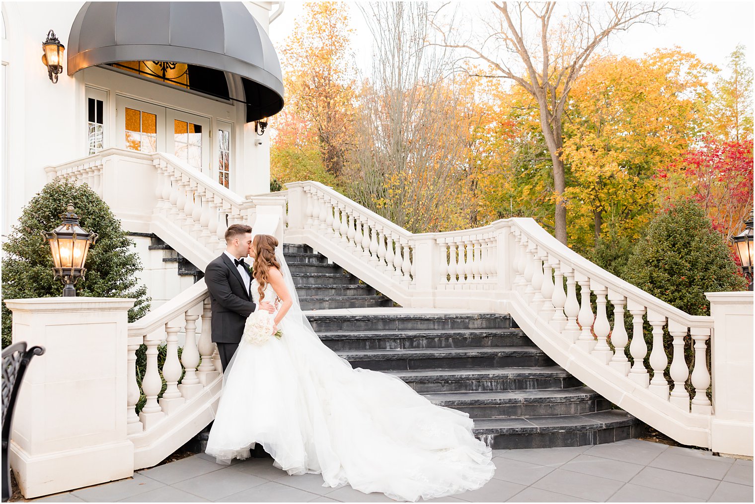 bride and groom kiss on staircase in New Jersey
