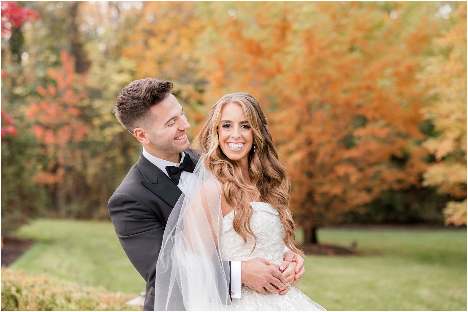 groom smiles hugging bride at Shadowbrook at Sherwsbury