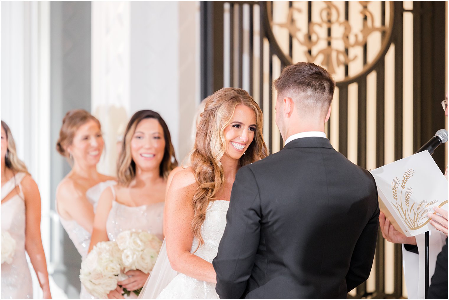 bride and groom hold hands during ceremony at Shadowbrook at Shrewsbury wedding