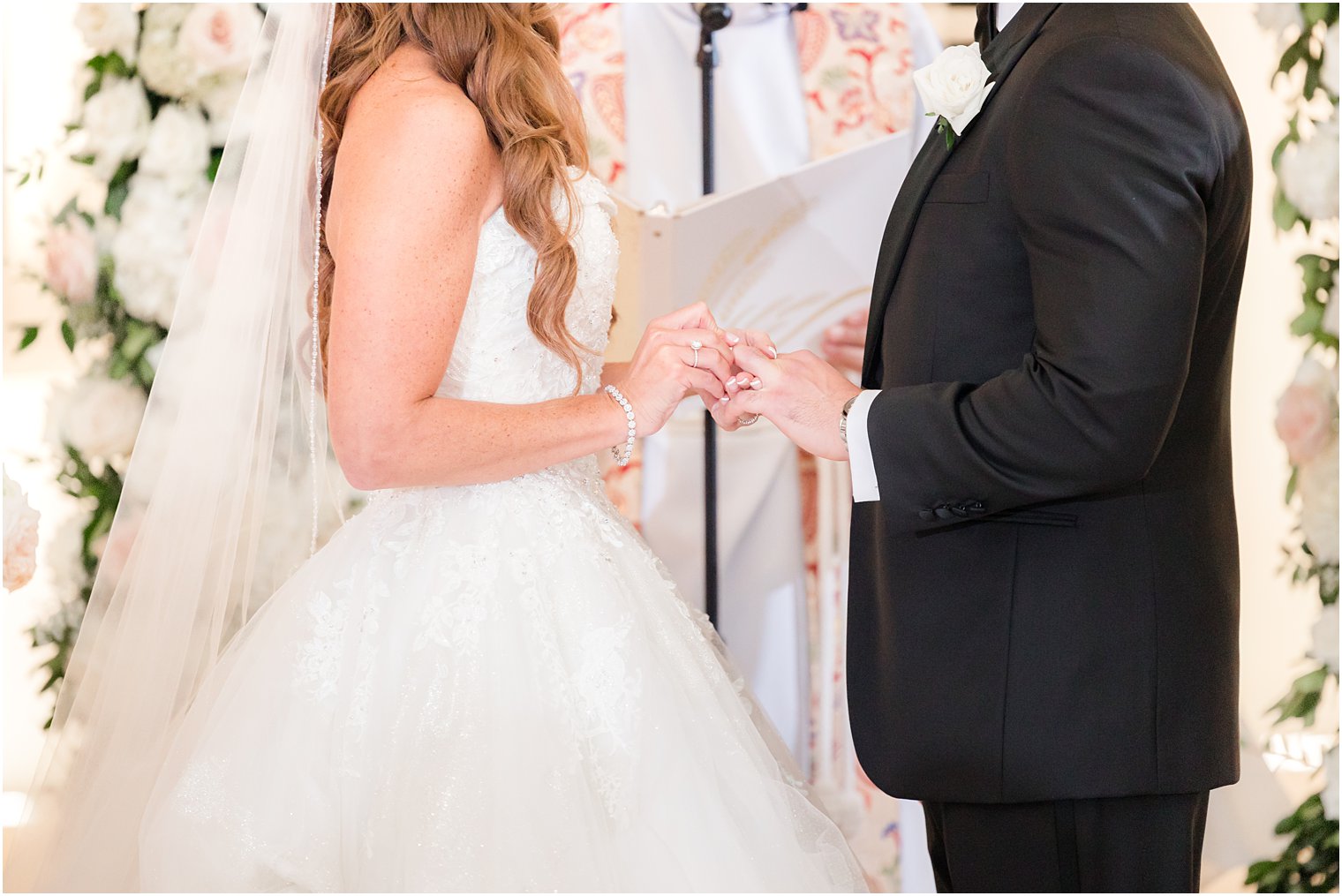 bride and groom exchange rings during ceremony in chapel at Shadowbrook at Shrewsbury wedding