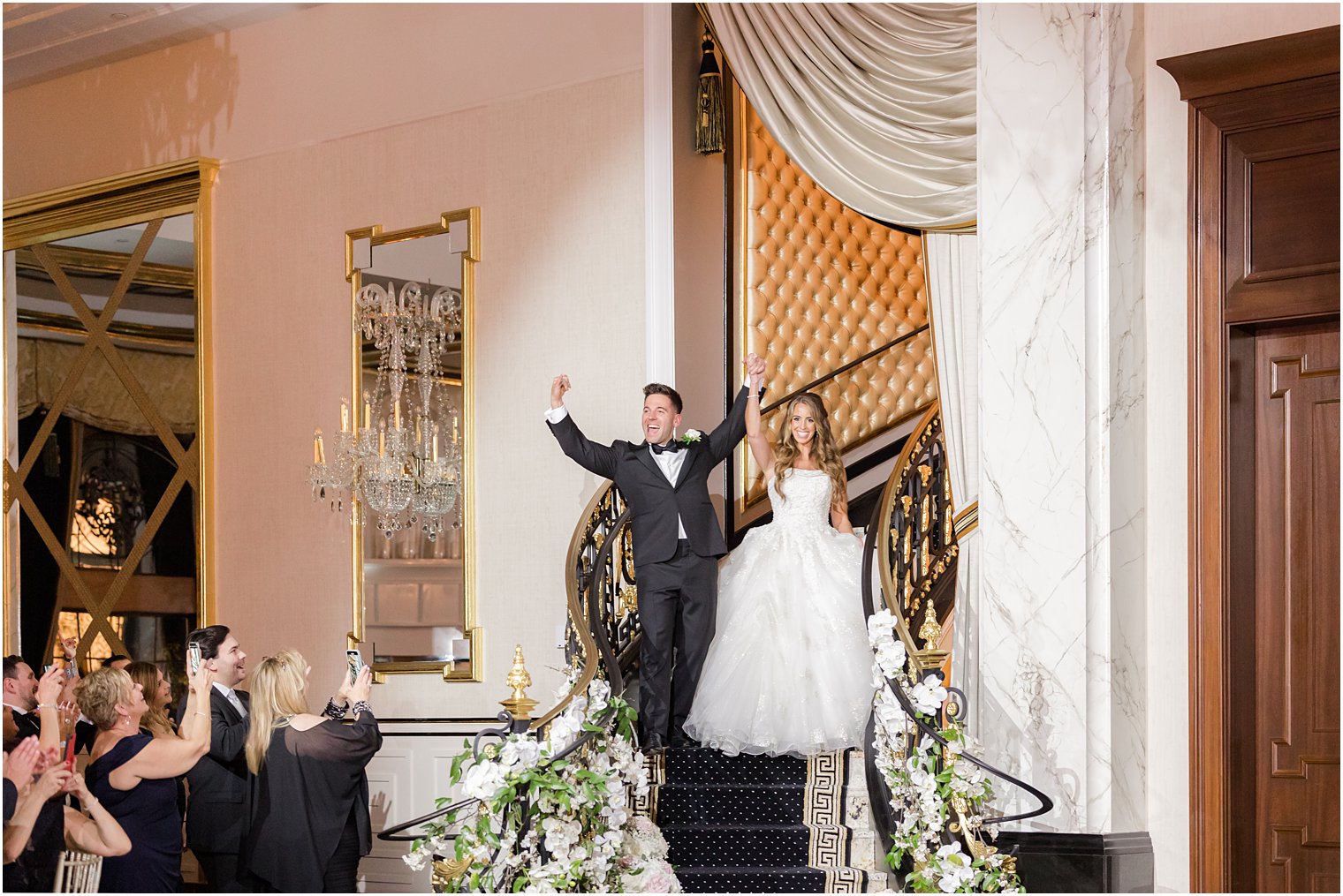 newlyweds cheer entering wedding reception 