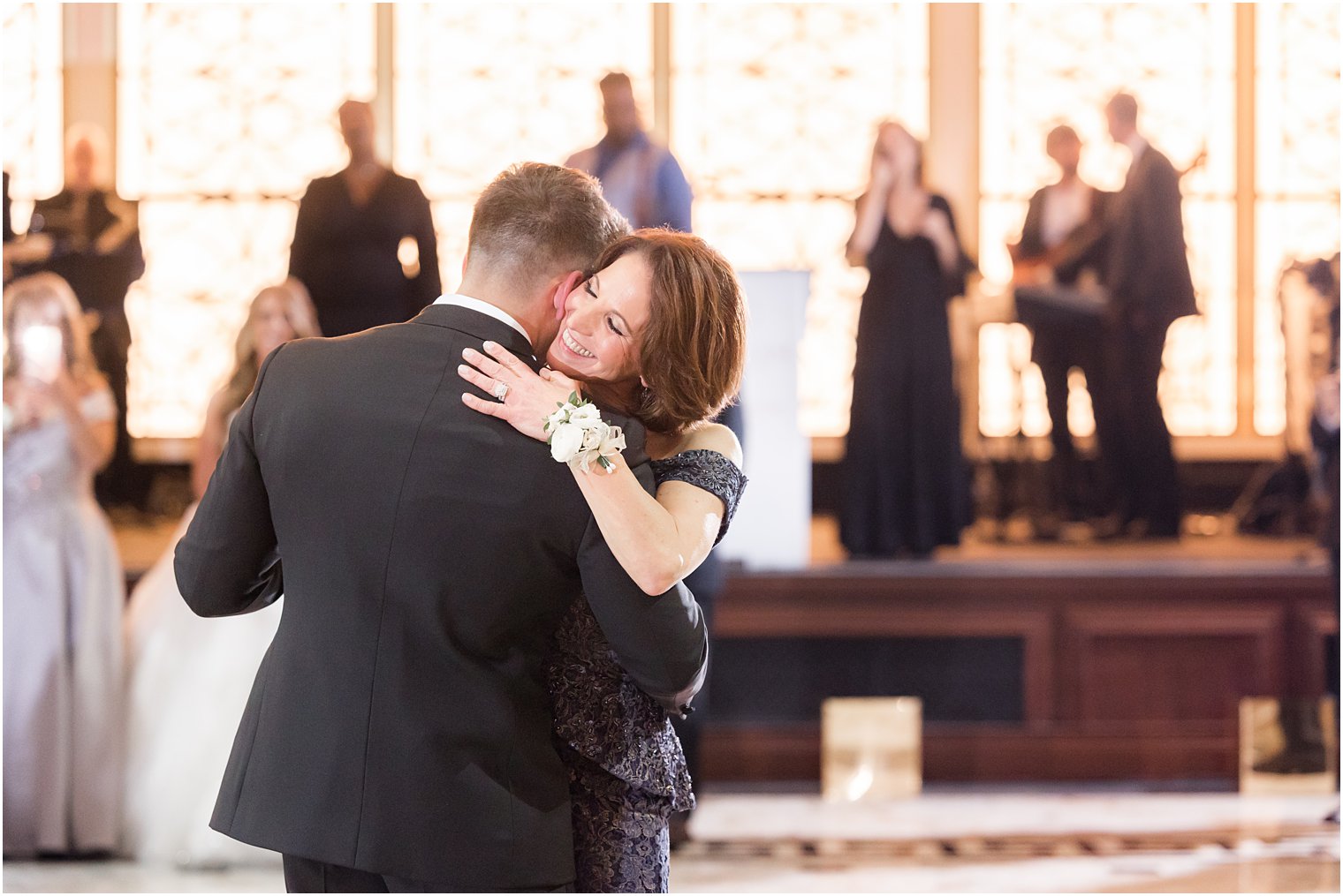 dad hugs mom on dance floor during reception 