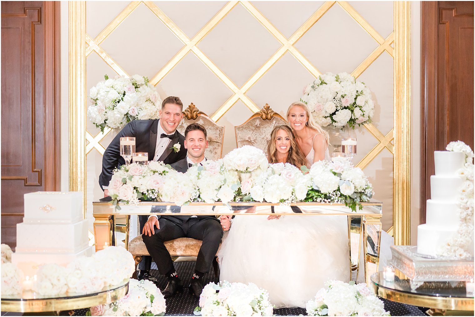 bride and groom pose with best man and maid of honor 