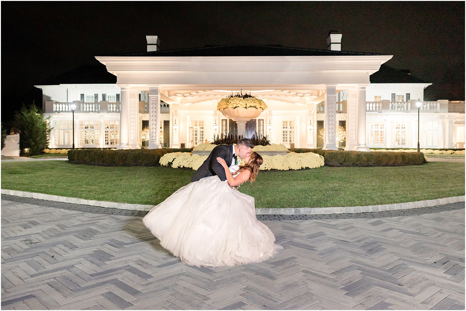 groom dips bride at night outside Shadowbrook at Shrewsbury