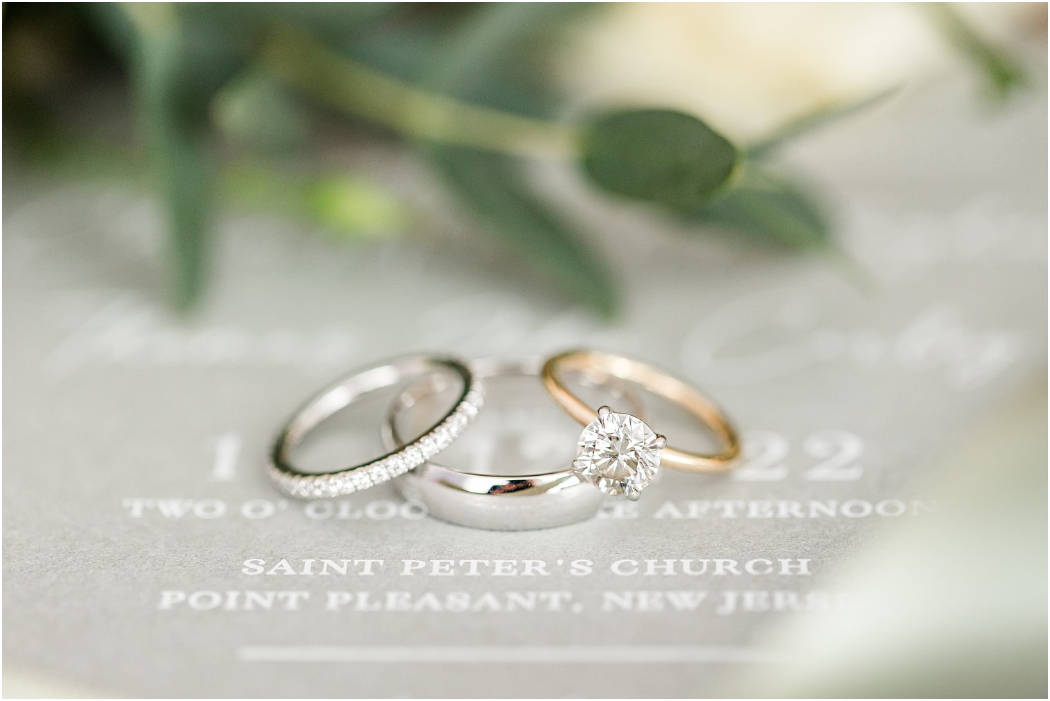 wedding bands rest on grey save-the-date in invitation suite 