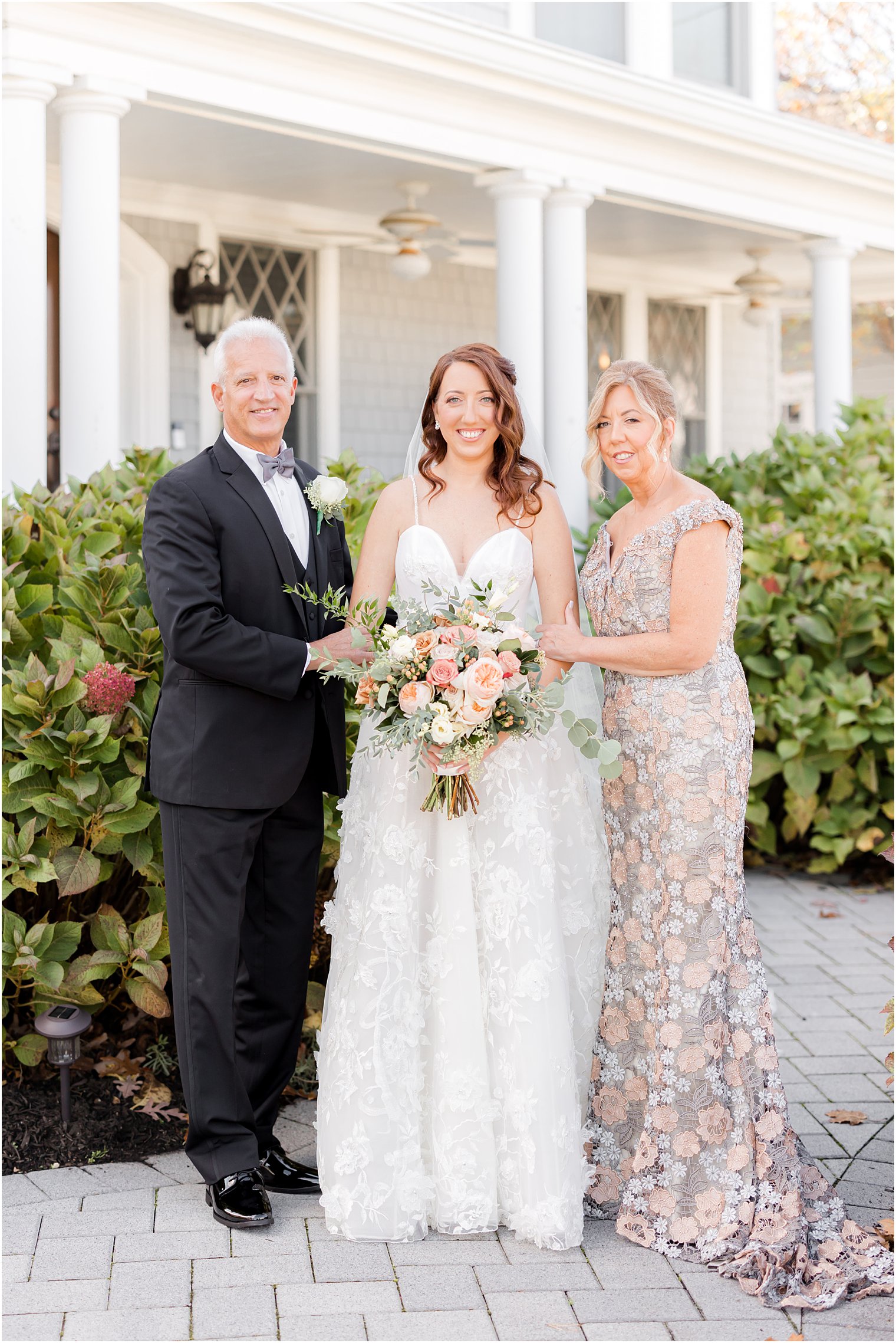 bride stands with parents outside New Jersey home 