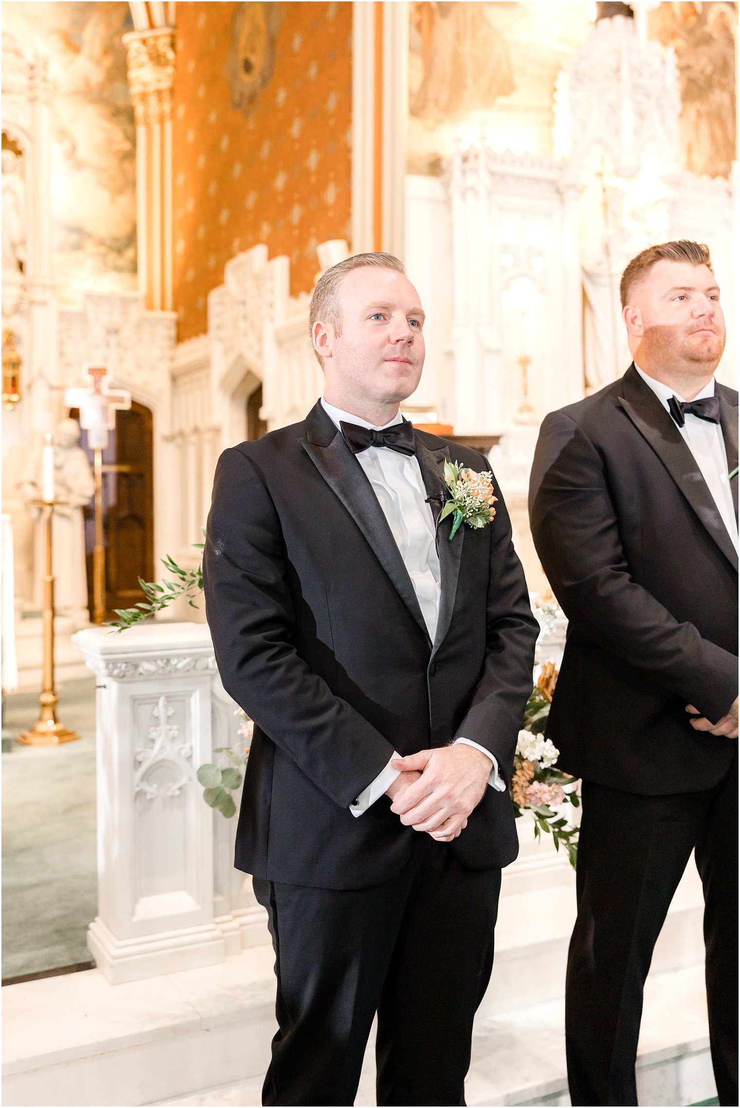 groom stands at alter waiting for bride in St. Peter's Church in Point Pleasant