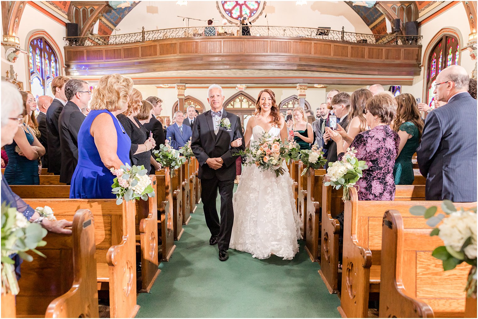 bride walks down aisle with father for traditional ceremony at St. Peter's Church in Point Pleasant