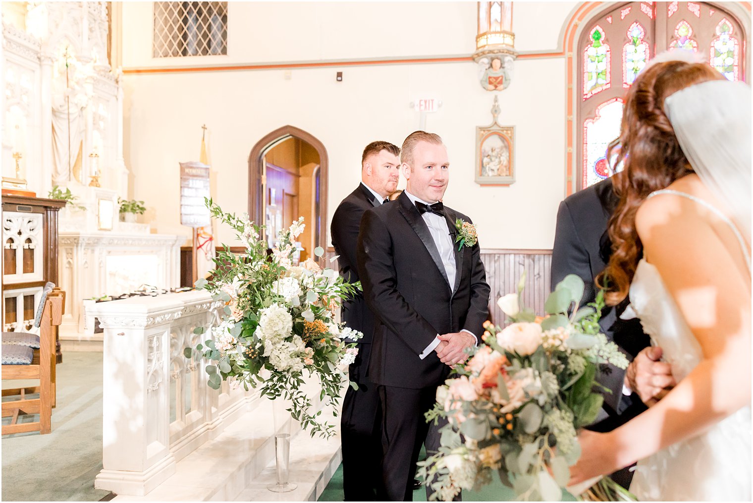 groom waits for bride at alter for traditional ceremony at St. Peter's Church in Point Pleasant